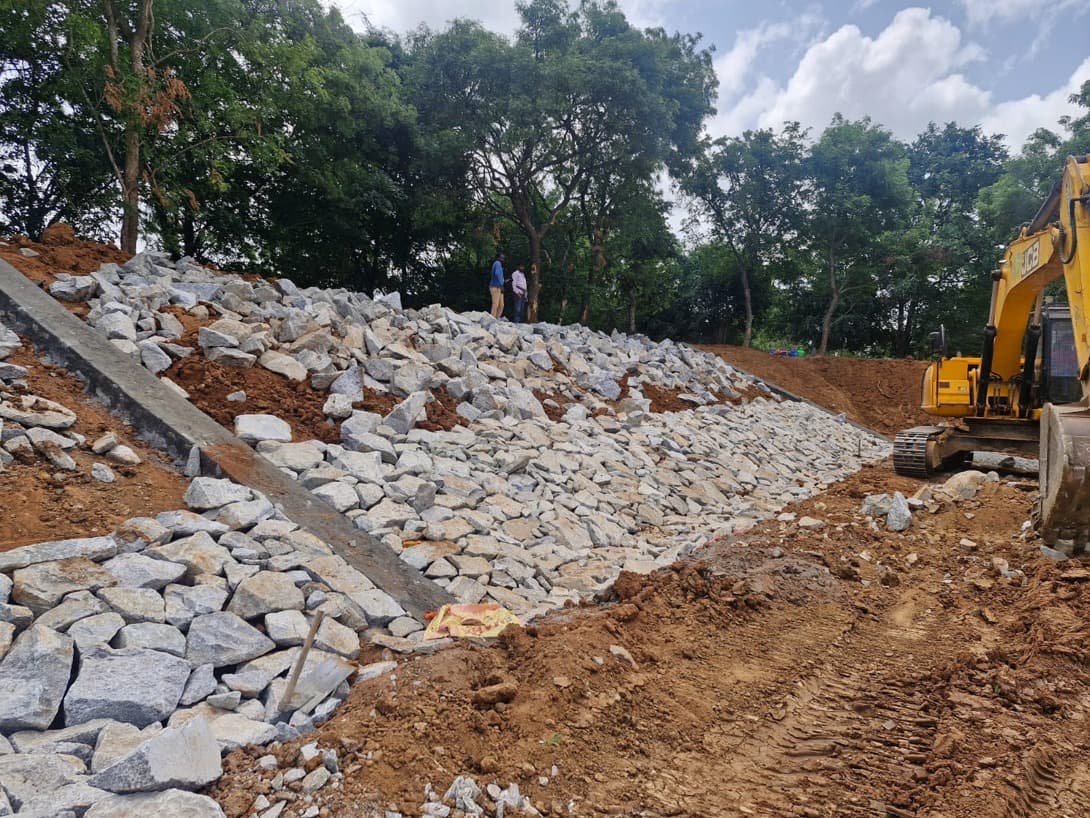 Kachamaranahalli lake bund protection work with stone pitching and excavator